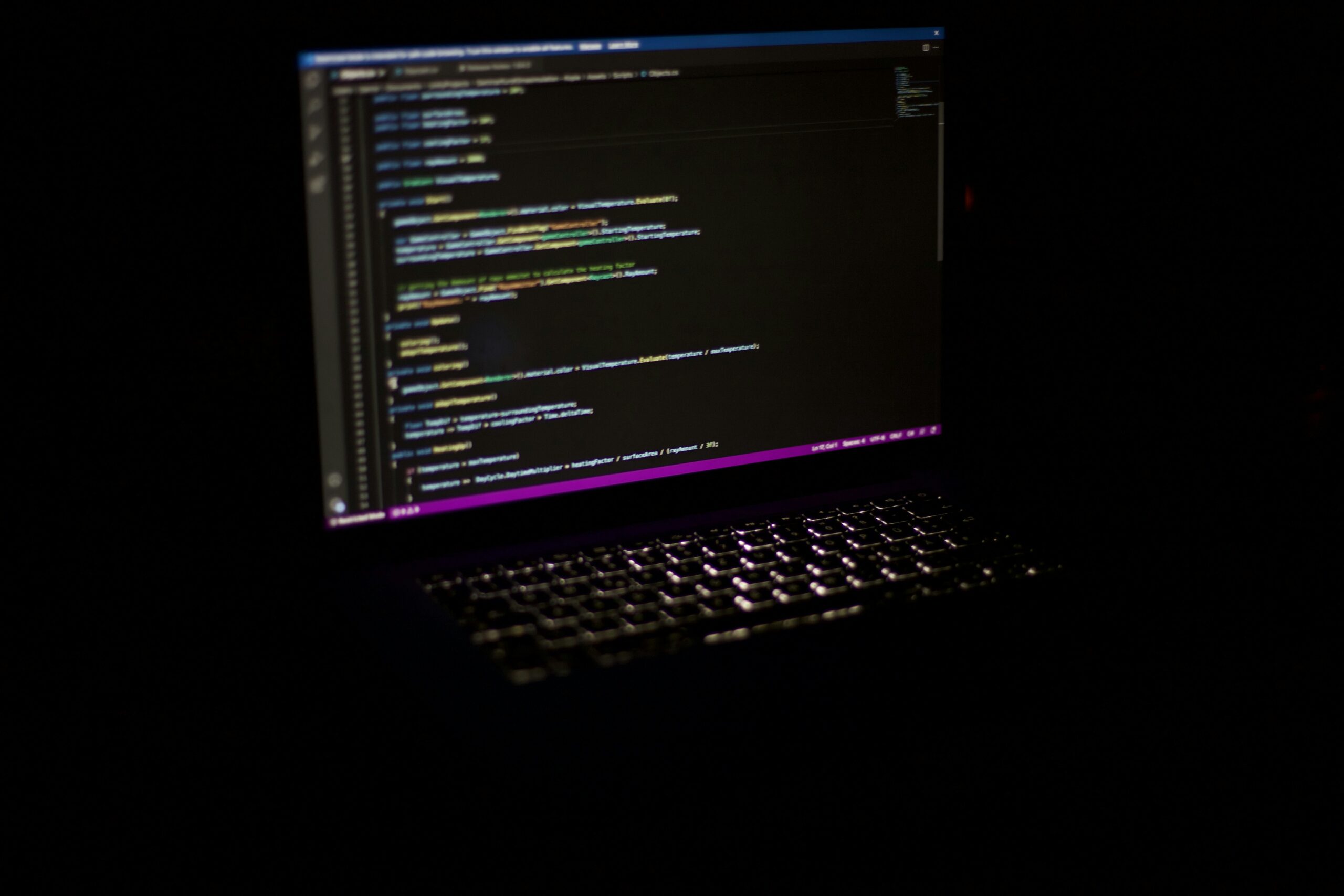 React JavaScript code on computer screen - a laptop computer sitting on top of a table